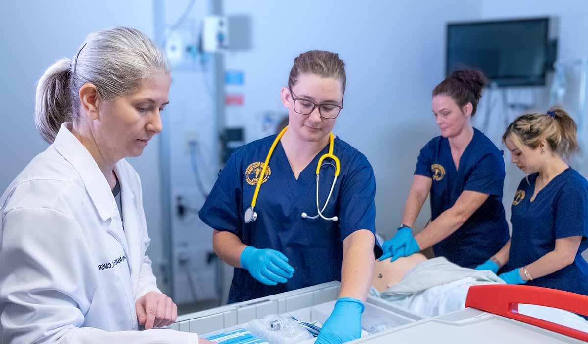 A nursing professor instructing her students